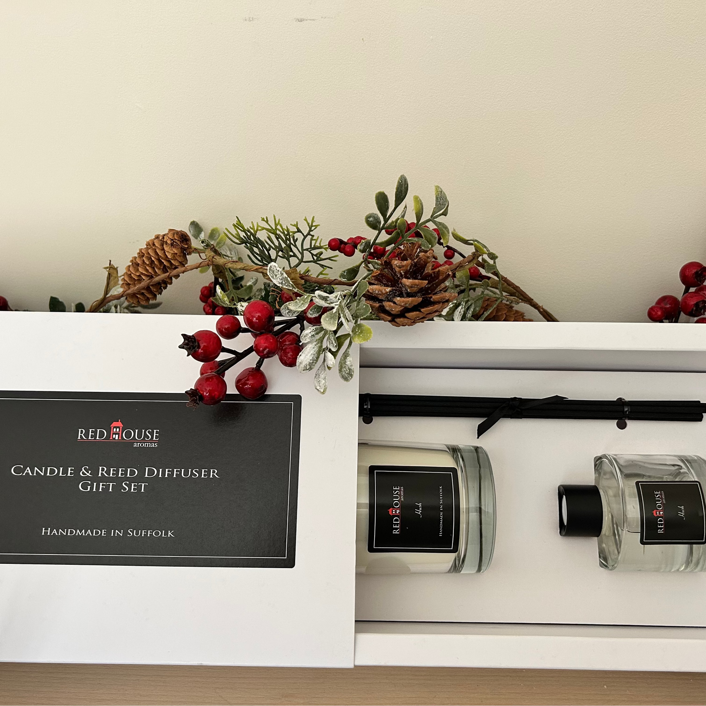 Red House candle and reed diffuser gift set in a white box with decorative elements.